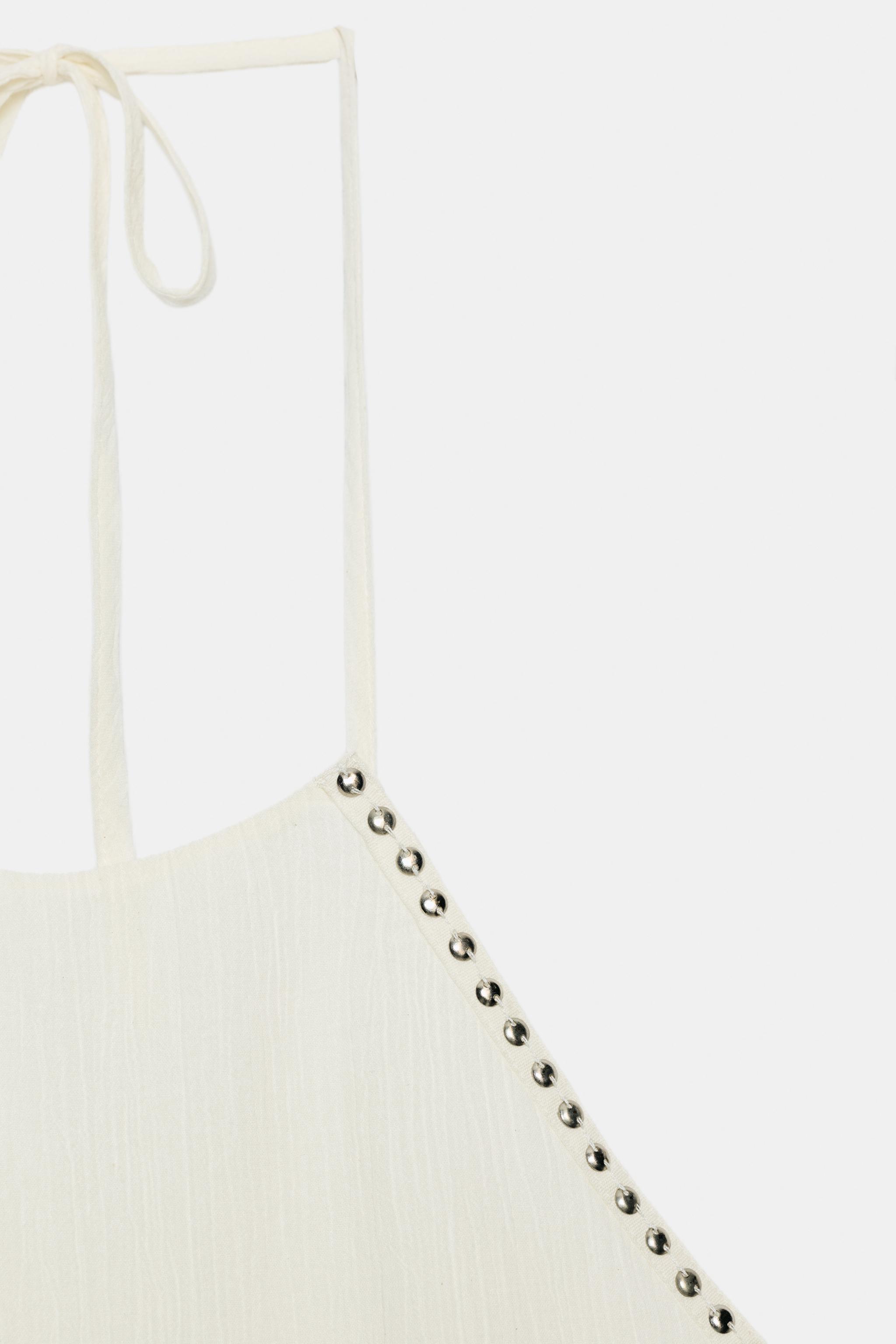 STUDDED RUFFLE HALTER TOP